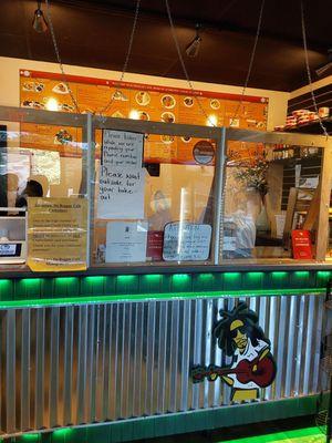 Front counter to order at- a clutter of signs