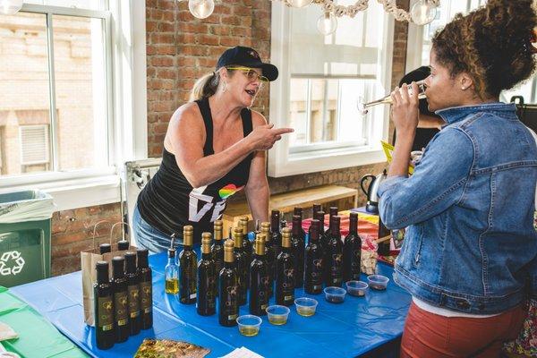 Janelle offering olive oil tastings at our Rainbow Bazaar