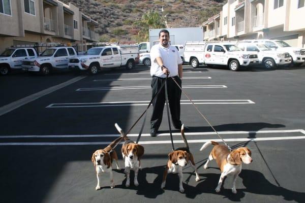 Round The Clock Pest Control Owner Robert Gallo with K-9 Grizz, Toby, Baby, and Herby.