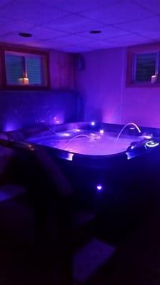 This is our indoor hot tub at night. Completely private with a resting couch and shower in the same room.