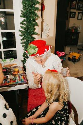 Mrs Claus doing wonderful face painting for our Christmas themed party