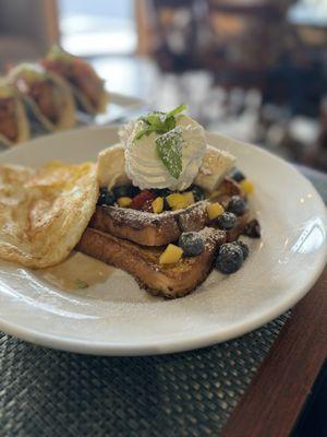 French toast with very fresh fruit and eggs.