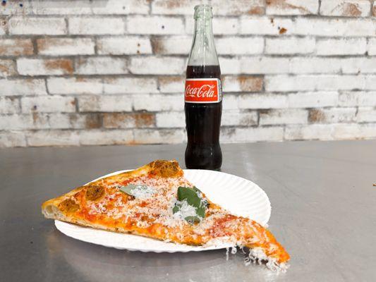 Cheese pizza slice and a Mexican Coke