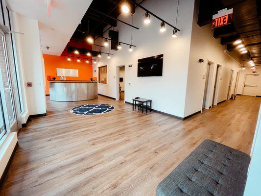 Spacious lobby with seating for students and TV.