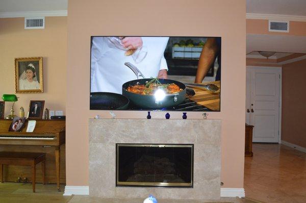 75" 4K UHD Samsung TV above fire place with pristine finish! All cable and wires concealed in-wall.