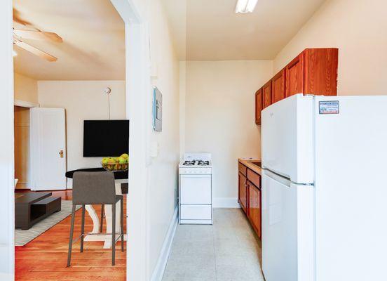 1818 Riggs Place Studio Apartments, classic kitchen, gas range stove, alley kitchen. Located in DuPont Circle DC