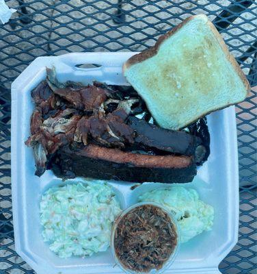 Brisket, Pork, and Ribs with Potato Salad and Cole Slaw on the side.