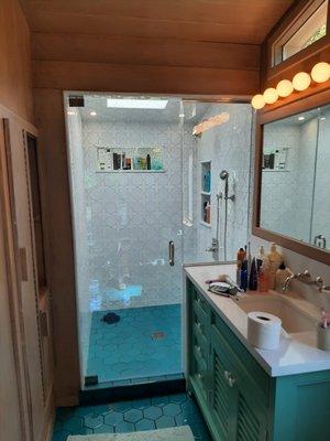 3/8" ShowerGuard Clear Glass shower pivot door with in-line panel installed with channel top and bottom