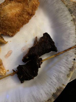 Burnt beef on a stick