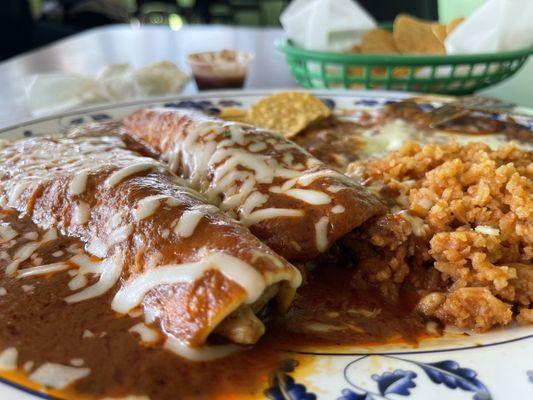 Enchilada plate comes with a side of chips if they give you a bottle water you'll get a two dollar service charge for that bottle