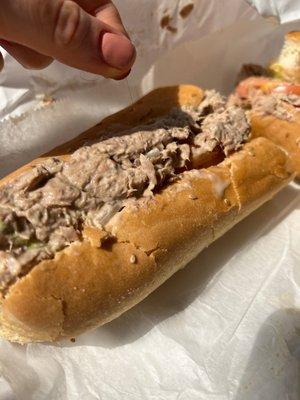 Tuna salad sub featuring an employee's hair