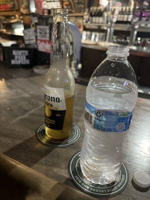 One corona and one water bottle = $13