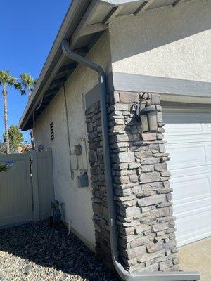 New side front garage gutters, and relocated location down tube away from electrical boxes