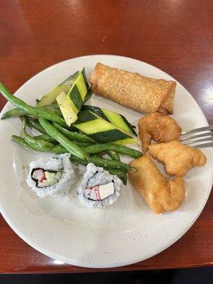 Sushi, sautéed vegetables, egg rolls, sweet and sour chicken