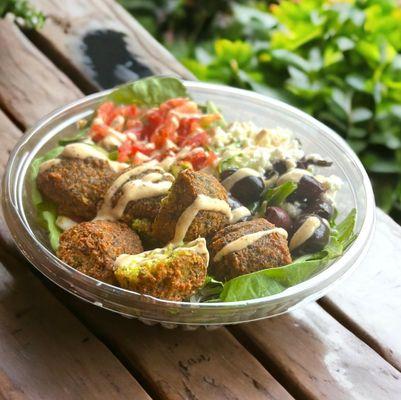 Arabica Salad: falafel, shirazi salad (cucumber, tomato and onions), feta, olives and tahini dressing on fresh greens (V, GF)