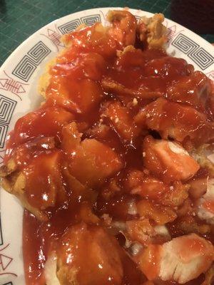 Chicken strips sliced up and covered in a thick gooey and bland sweet and sour sauce.