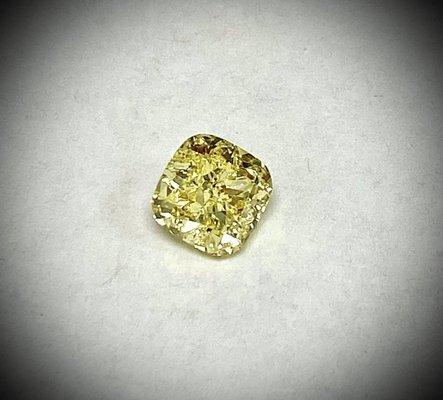 Natural Fancy Yellow Intense Cushion Diamond.