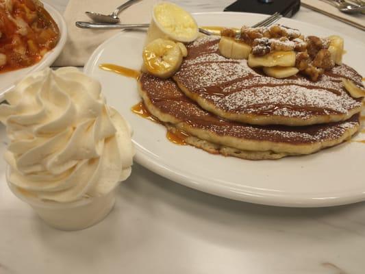 Banana walnut pancakes with powdered sugar and a rum sauce. Delish!