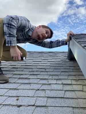 Lahar Home Inspections trying to get a better look at the roof.