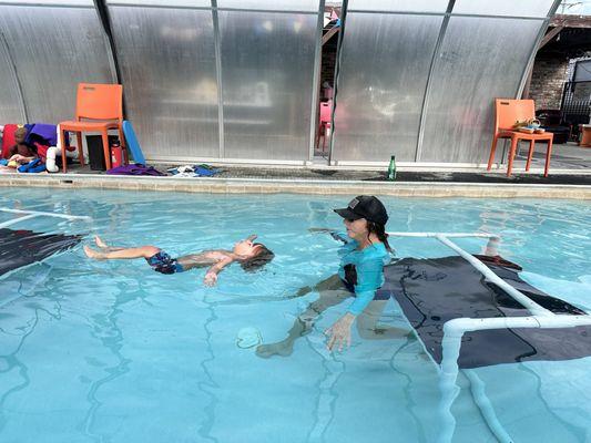 Jonah floating on his back in survival swimming with Miss Kris's swimming lessons