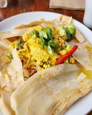 Basic breakfast crepe with scrambled tofu, vegan cheddar, sauteed vegetables, and avocado