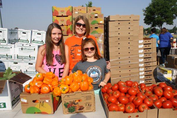 Volunteers help distribute food at one of our mobile pantries. Did you know about 25% of the food we distribute is fresh produce?