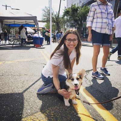 Dr. Greco greeting a furry visitor to their booth at the Merrick Chamber Festival