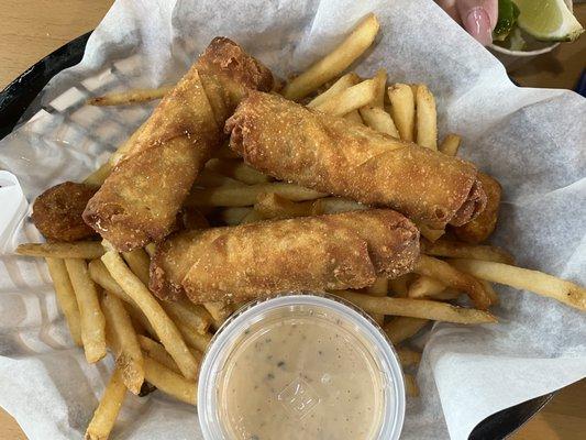 Omg fried boudin egg rolls with a side of fries and a dipping sauce!