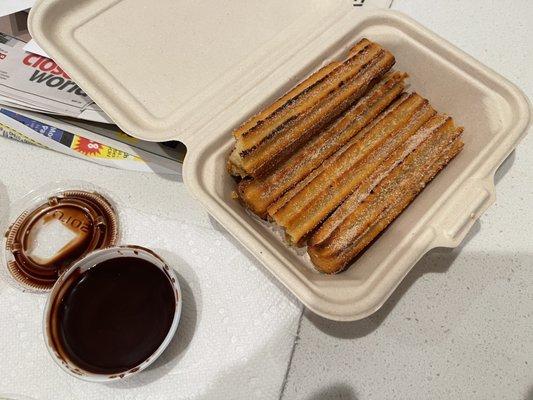 Caramel filled churros with chocolate sauce.