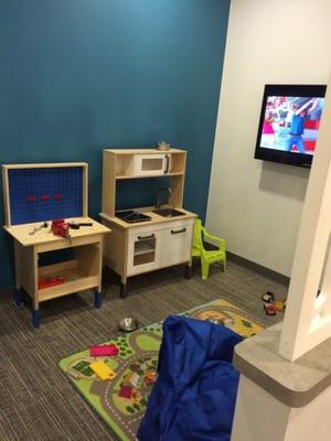 Cute kids waiting room with kids movie on