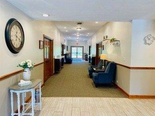 Updated Hallway with new carpet, plenty of natural light, and comfortable seating