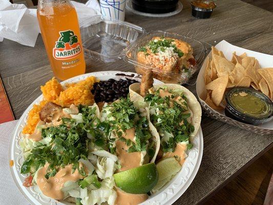 Fish tacos, Mexican style corn, chips with verde salsa