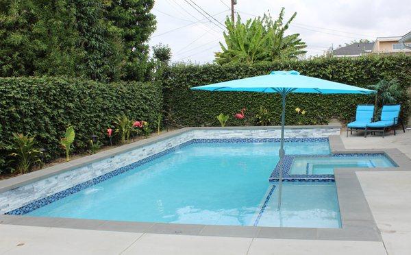 East Long Beach Pool and Spa transformed this backyard by building a pool and spa with an elevated planter.