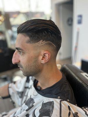 Mid drop skin fade with a design. Cut by soni