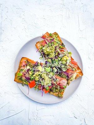 Bjorn's Breakfast: ciabatta grilled on the panini, topped with smashed avocado, pesto, chopped tomato, bacon, and micro greens.