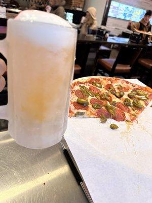 Pepperoni and jalapeño pizza with a Pilsner on the side