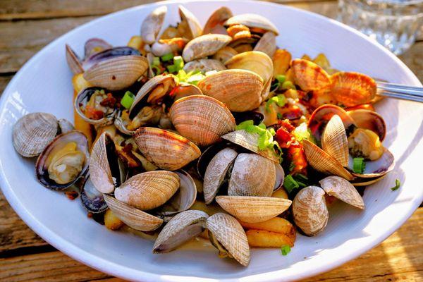 Poutine of the Sea: chowder-style gravy, steamed clams, fries, scallions, bacon ($23).