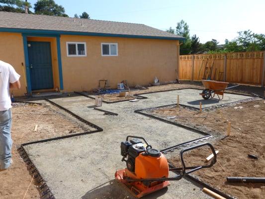 This photo shows the gravel base that will support the stone path and patio. The black edging also stabilizes the stone.