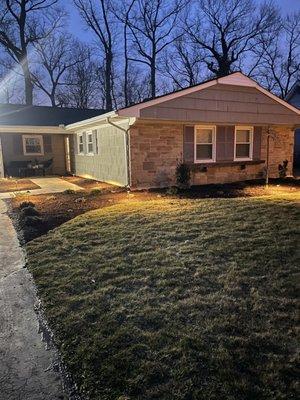 After photo a recent renovation.  New walkway, sod, lighting, paver patio and sitting wall.