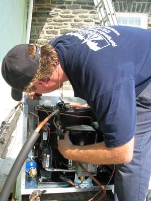 Atlantic technician soldering on roof top condensing unit