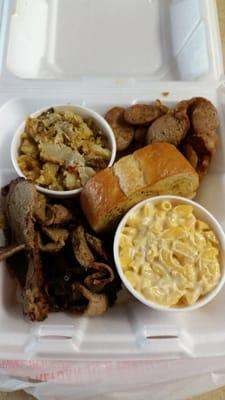 Dinner platter- beef brisket, smoked sausage, garlic bread, mac and cheese, and potato casserole