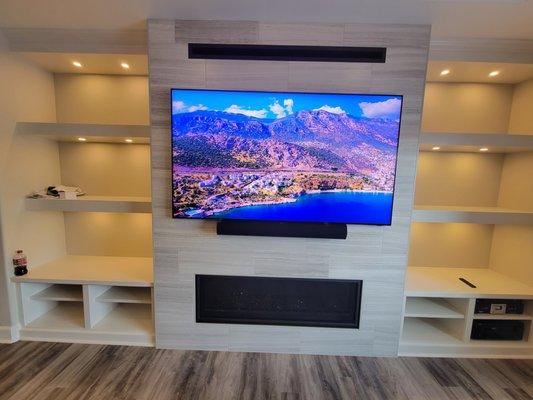 Large Flat Panel TV and sound bar, all part of a beautiful audio video system sold by Mile High Audio Video