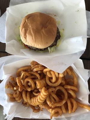 Single-patty burger and spicy curly fries