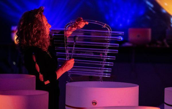 Dr. Gigi Turner playing a quartzozphone during a sound bath in Colorado Springs, CO