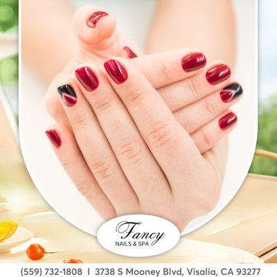 Turn heads with our classic red nail shades! Only at Fancy Nails Salon.  #ClassicRed #NailSwag"