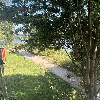 Below the patio, there's a walkway along the river