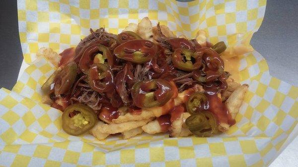 These are our Loaded Fries topped with pulled pork mild BBQ sauce and jalapenos