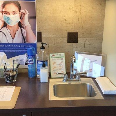 Hand washing station for check-in. Cleaned between each patient.