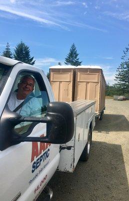 One of the owners, Dana, helping deliver portable restrooms during a busy summer day.