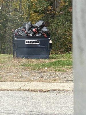 Unsanitary overflowing trash and garbage in a Casella bin